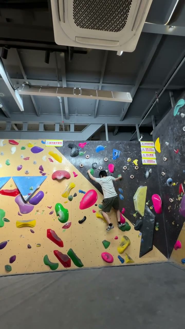 Climber reaching across the wall